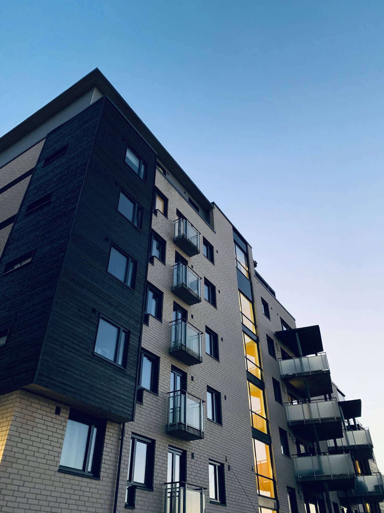 Brick and dark-clad apartment building with balconies
